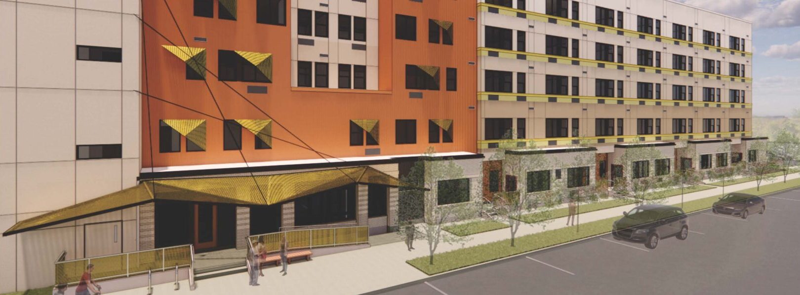 Modern multi-story building with orange and beige facade, featuring yellow awnings and large windows, surrounded by greenery and parked cars