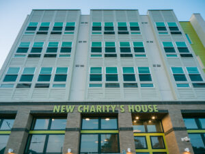 New Charity's House building facade with multiple windows and entryway.