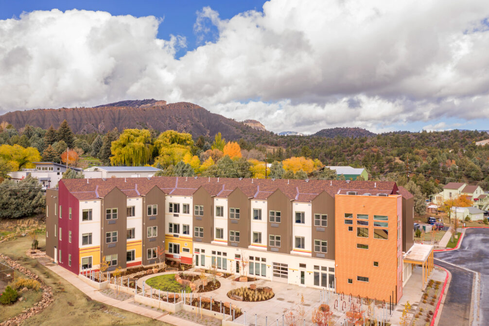 Espero building exterior with autumn trees and mountainous backdrop