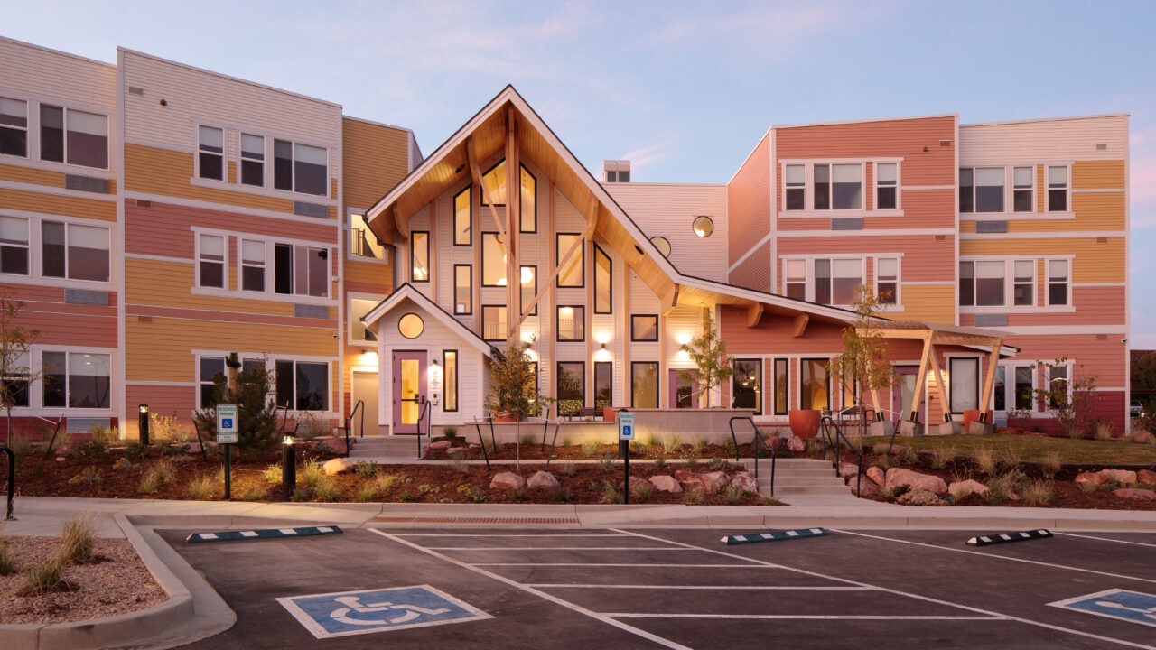Modern building exterior with large windows and colorful facade.