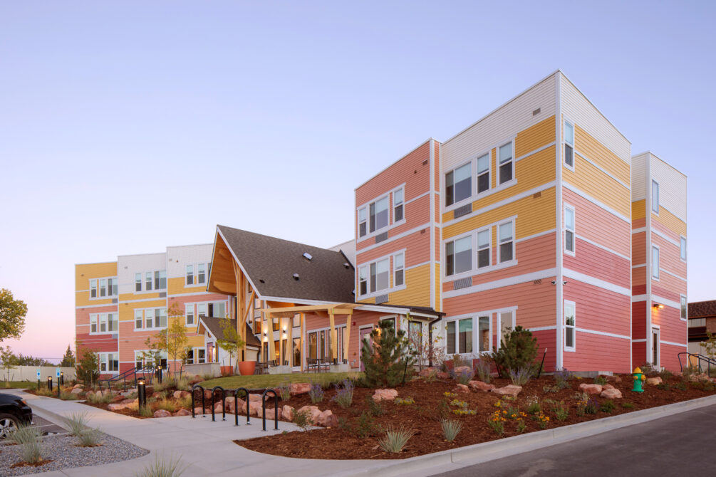 Laurel House exterior; colorful, multi-story buildings with landscaped gardens at sunset.