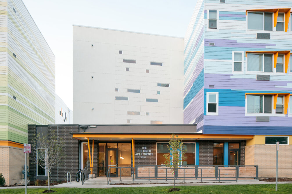 The Delores Apartments modern exterior with colorful facade and large windows