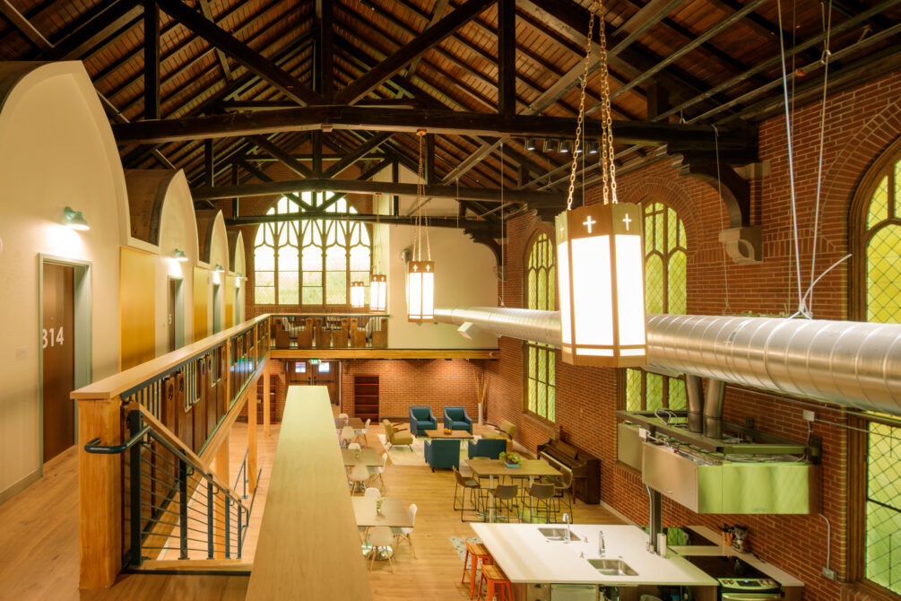 Spacious, brightly-lit loft with high ceilings, wooden beams, and modern seating. Room number 314 visible upstairs.