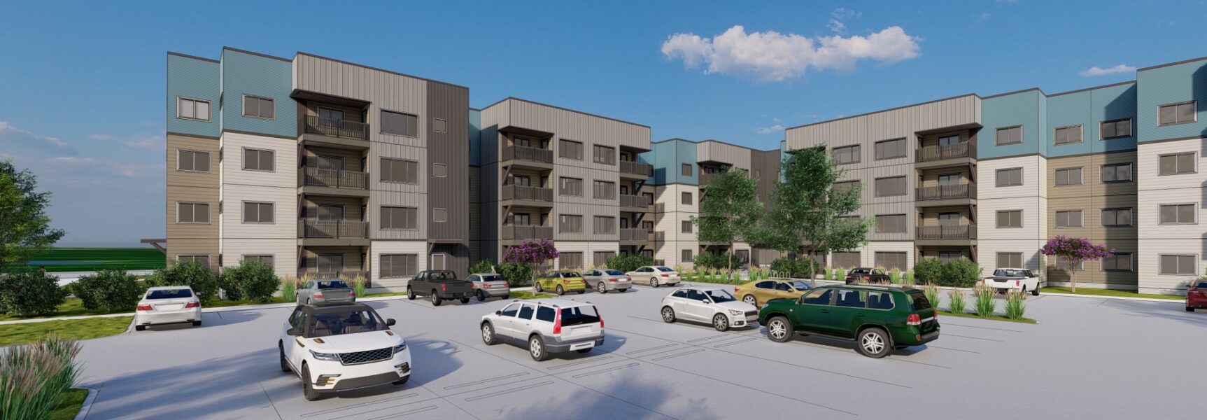 Modern apartment complex with four stories, surrounded by a parking lot and trees