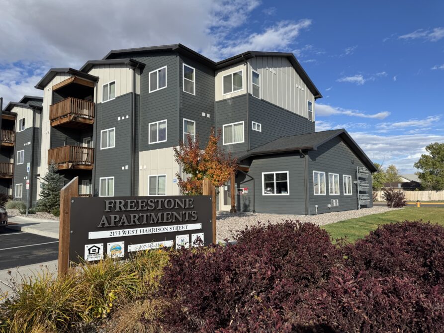 Freestone Apartments building with a sign reading "2173 West Harrison Street" in the foreground.