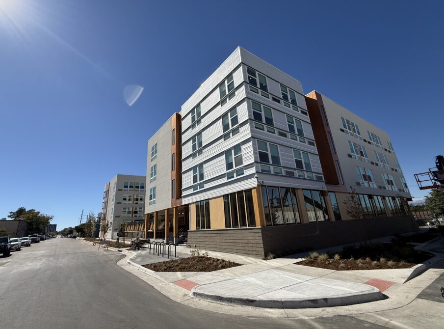Modern apartment building on a sunny day with clear sky.