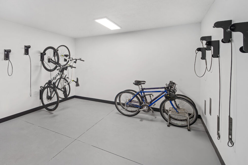 Bike storage room with wall mounts and a blue bike.