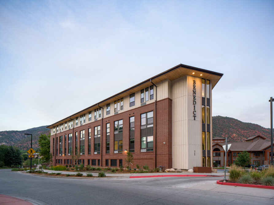 TheBenedict exterior with red brick facade and mountain backdrop
